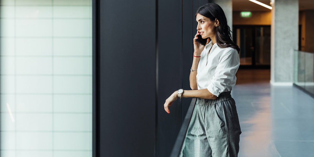 woman in office looking out window