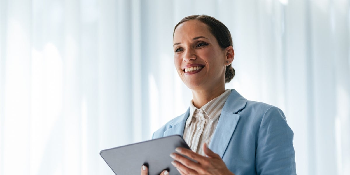 woman in office holding tablet