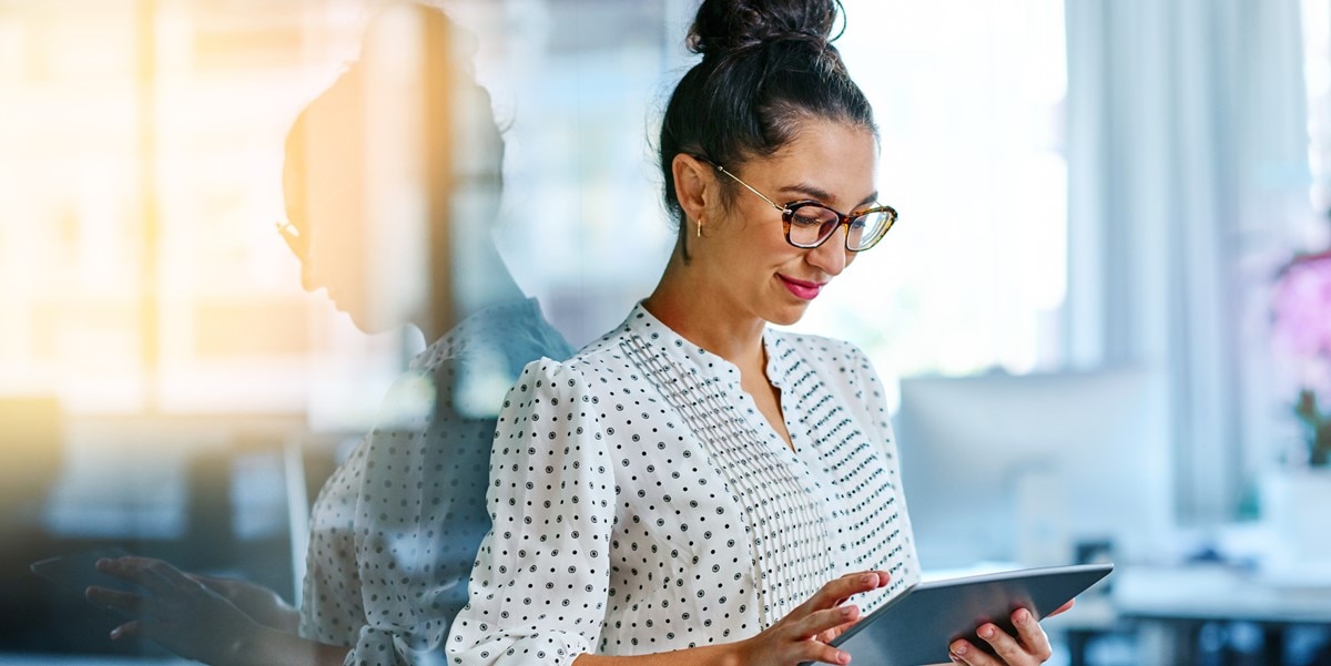 woman in office looking at tablet